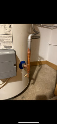 Close-up of copper pipework and a gate valve on a hot water cylinder